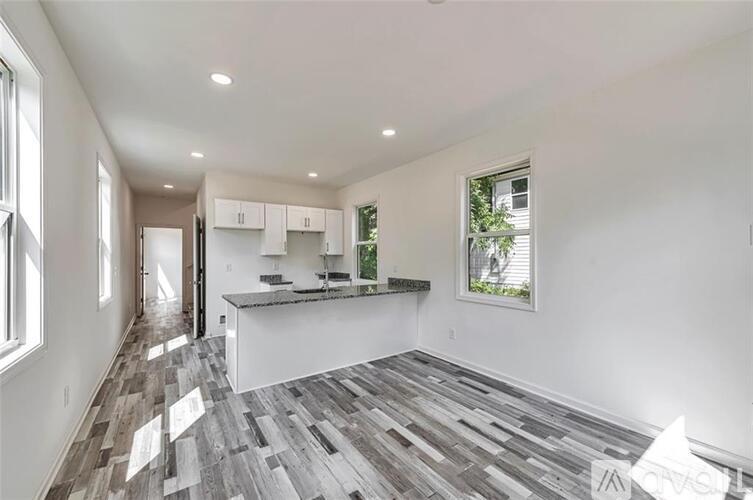 A spacious kitchen with a large island and a view of the backyard.