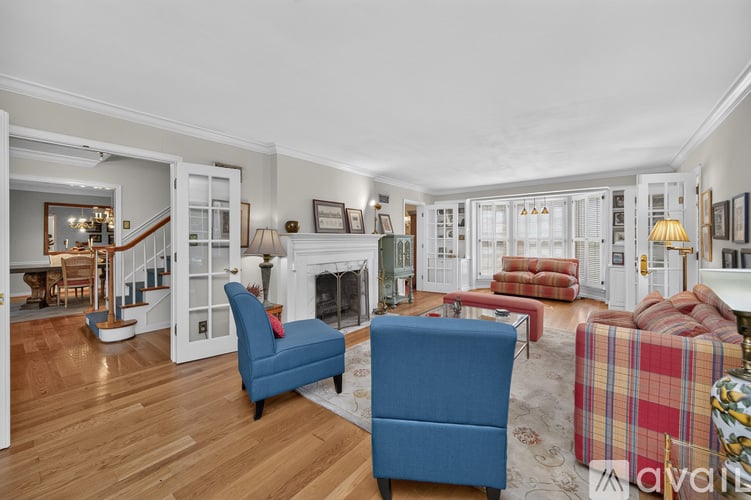 A living room with a fireplace and a blue chair.
