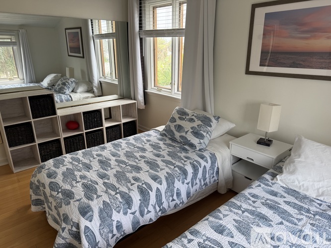 A bedroom with a large bed and a smaller bed in the corner.