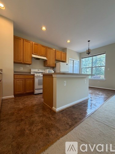 A kitchen with brown cabinets and a white island.
