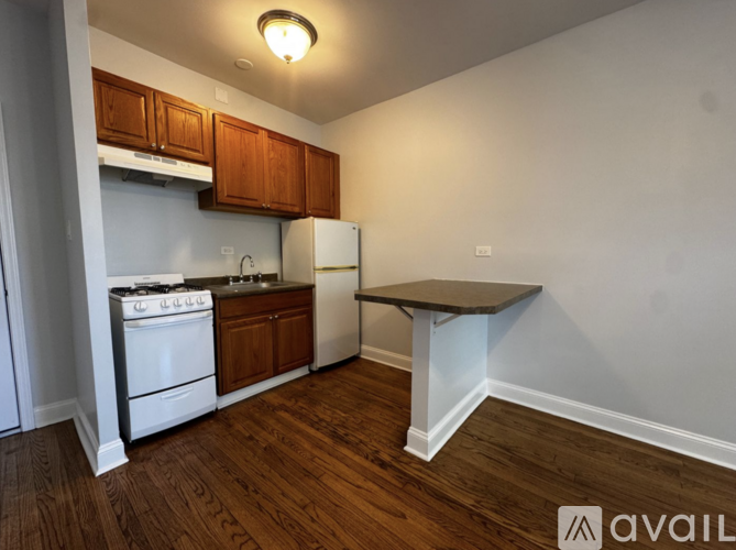 A kitchen with white appliances and wooden cabinets.