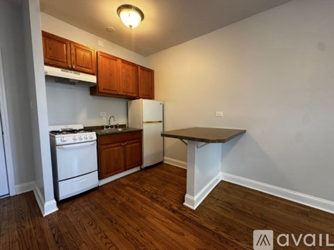 A kitchen with white appliances and wooden cabinets.