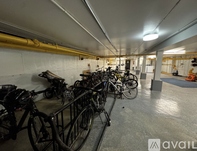 A bike rack with several bicycles parked inside a building.