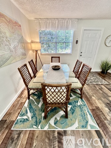 A dining room with a table set for six.