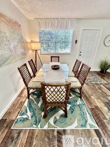 A dining room with a table set for six.