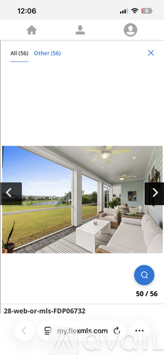 A modern house with a large open floor plan and a view of a grassy field.