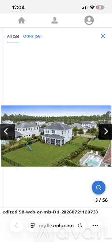 A large white house with a pool in the backyard.