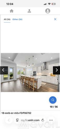 A modern kitchen with a dining table and chairs.