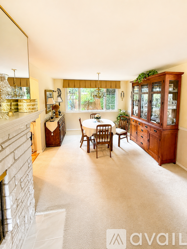 A dining room with a table set for four.
