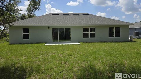 A house with a grey roof and white walls is available for purchase.