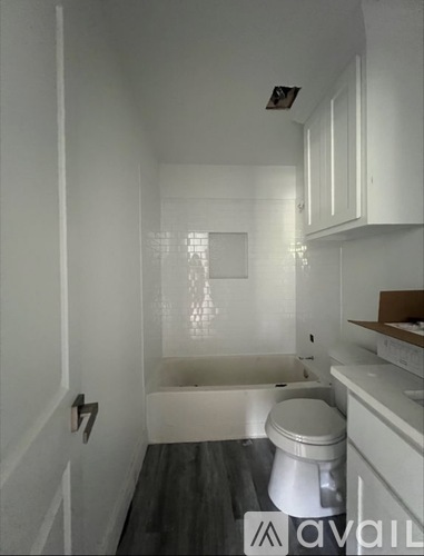 A bathroom with a toilet, sink, and bathtub.