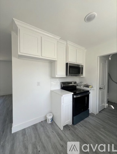 A kitchen area with a microwave, oven, and cabinets.