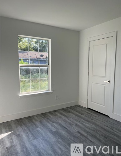 A room with a window and a door.