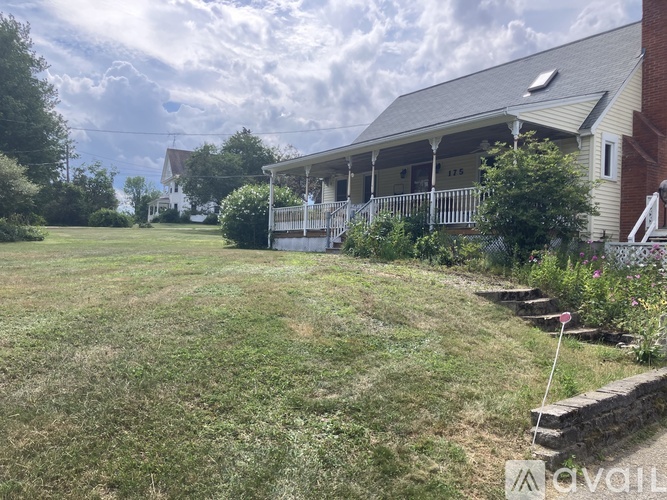 A house with a lawn in front of it.