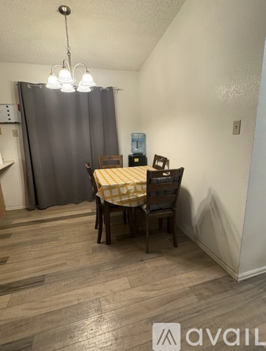 A dining room with a table and chairs.