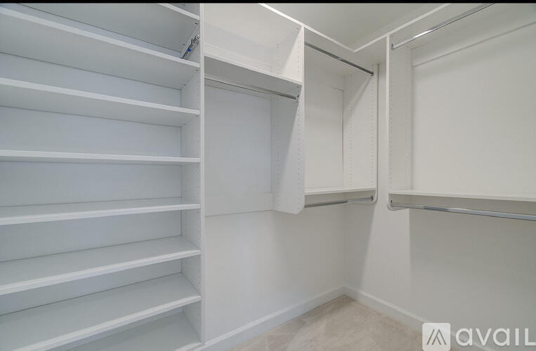 A white closet with shelves and hanging space.