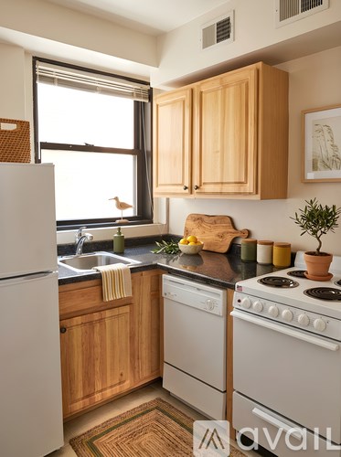 A kitchen with wooden cabinets and white appliances.