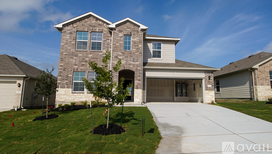 A house with a garage and a driveway in front.
