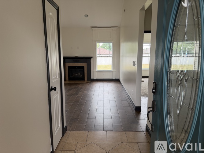 A room with a fireplace and tile flooring.