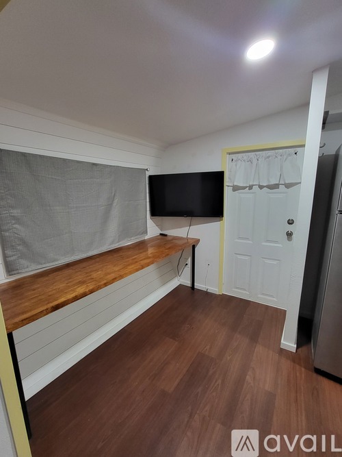 A small room with a bench and a door.