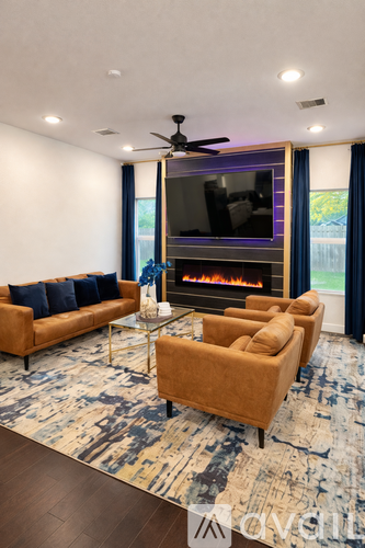 A living room with a fireplace, a sofa, a coffee table, and a television.