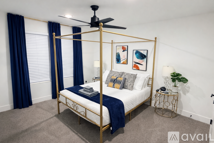 A bedroom with a four poster bed and a ceiling fan.