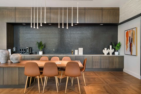 A modern dining room with a wooden table and chairs.