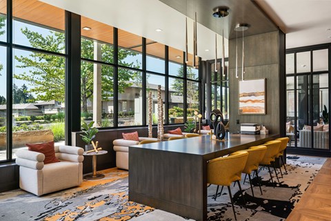 A modern living room with a long wooden table and yellow chairs.
