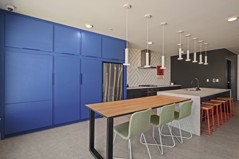A modern dining area with a wooden table and green chairs.