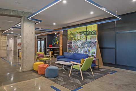 A modern lounge area with a large mural on the wall.