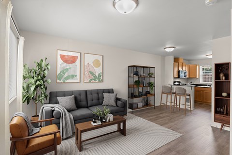 A living room with a grey couch and a wooden coffee table.