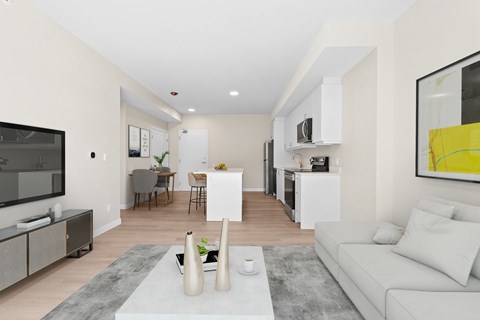 A modern living room with a grey rug and a white couch.