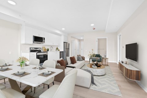 A modern living room with a dining table set for four.