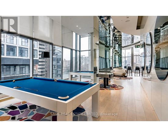 A pool table in a room with a view of the city.