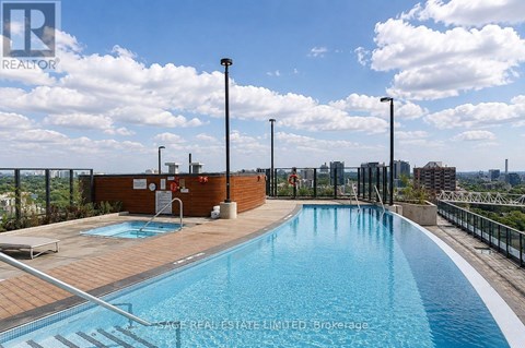 A swimming pool with a view of the city in the background.