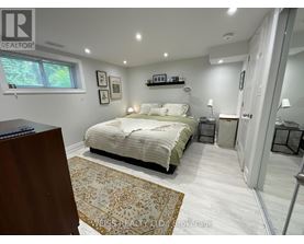 A bedroom with a bed, nightstands, and a rug.
