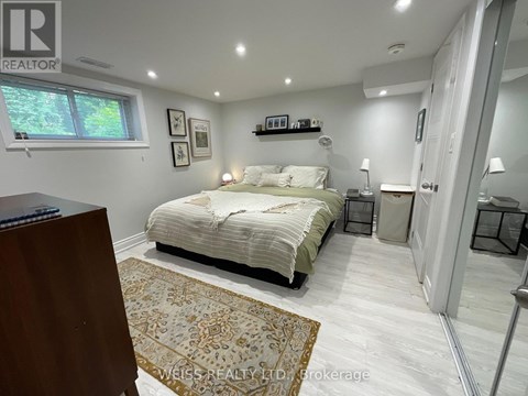 A bedroom with a bed, nightstands, and a rug.