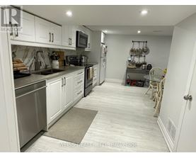 A kitchen with white cabinets and stainless steel appliances.