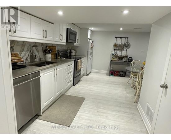 A kitchen with white cabinets and stainless steel appliances.