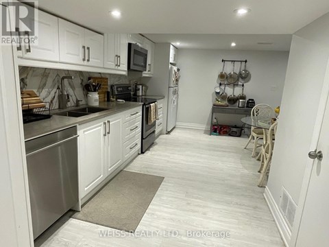A kitchen with white cabinets and stainless steel appliances.