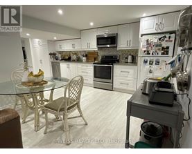 A kitchen with a table and chairs.