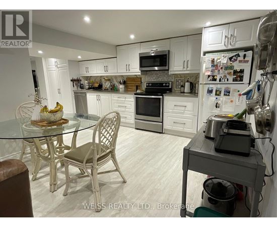 A kitchen with a table and chairs.