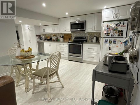 A kitchen with a table and chairs.