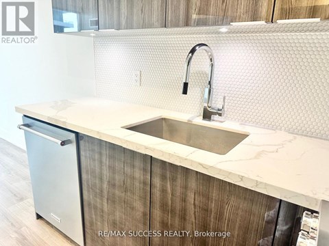 A modern kitchen with a sink and a dishwasher.