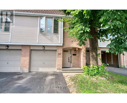 A house with a garage and a tree in front of it.