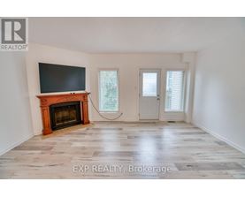 A room with a fireplace and a flat screen TV mounted on the wall.