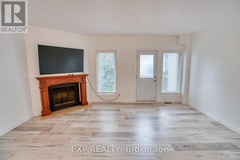 A room with a fireplace and a flat screen TV mounted on the wall.