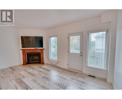 A room with a fireplace and sliding doors.