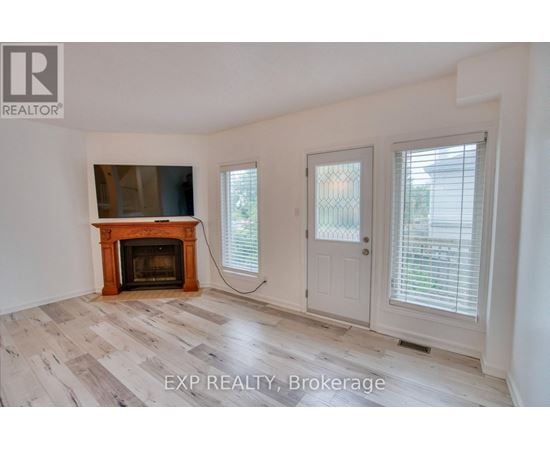 A room with a fireplace and sliding doors.