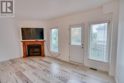 A room with a fireplace and sliding doors.